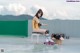 A woman sitting on top of a chair next to a box.