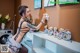 A woman in lingerie cleaning a shelf with teddy bears.